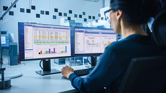 Modern Electronics Factory: Female Electrical Engineer Works on Computer with CAD Software. Developing PCB, Microchips, Semiconductors and Telecommunications Equipment