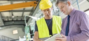 tech and manager working to calibrate equipment