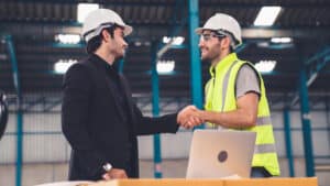 Two,Factory,Workers,Working,And,Discussing,Manufacturing,Plan,In,The