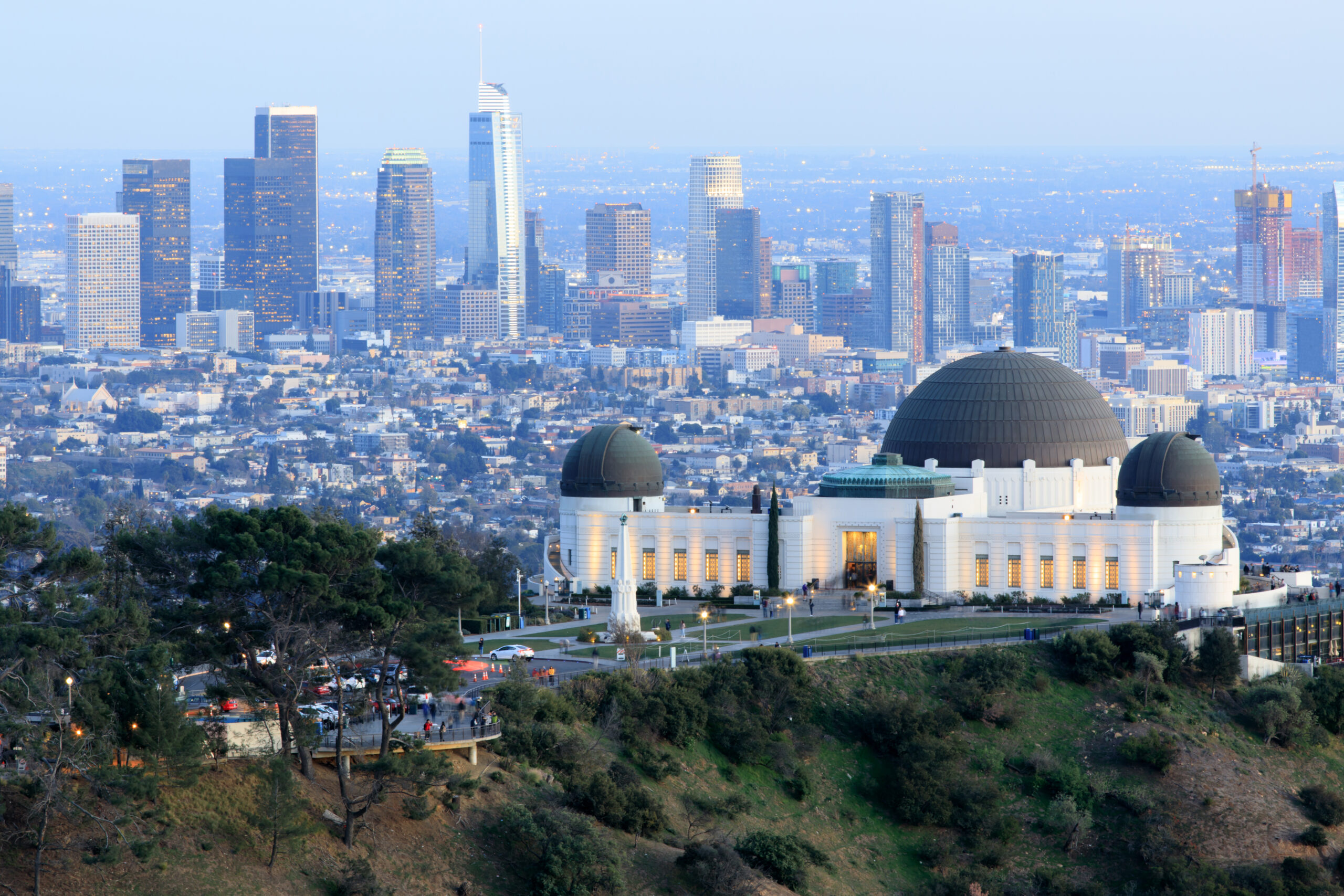 Griffith Observatory Park with Los Angeles Skyline at Dusk. Twilight views of the famous monument and downtown from Santa Monica Eastern Mountains. Los Angeles, California, USA.