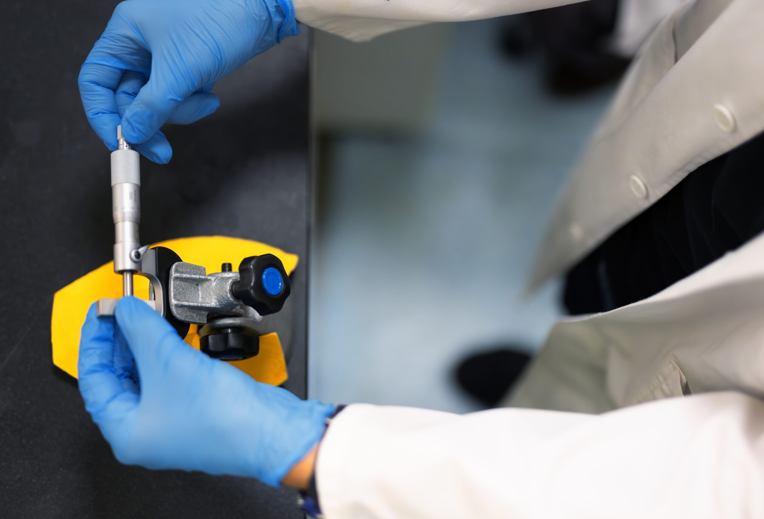 Laboratory,Technician,Using,A,Precision,Micrometer,To,Measure,A,Metal