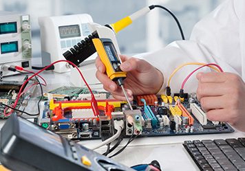 Repairman fixes electronic equipment in service center