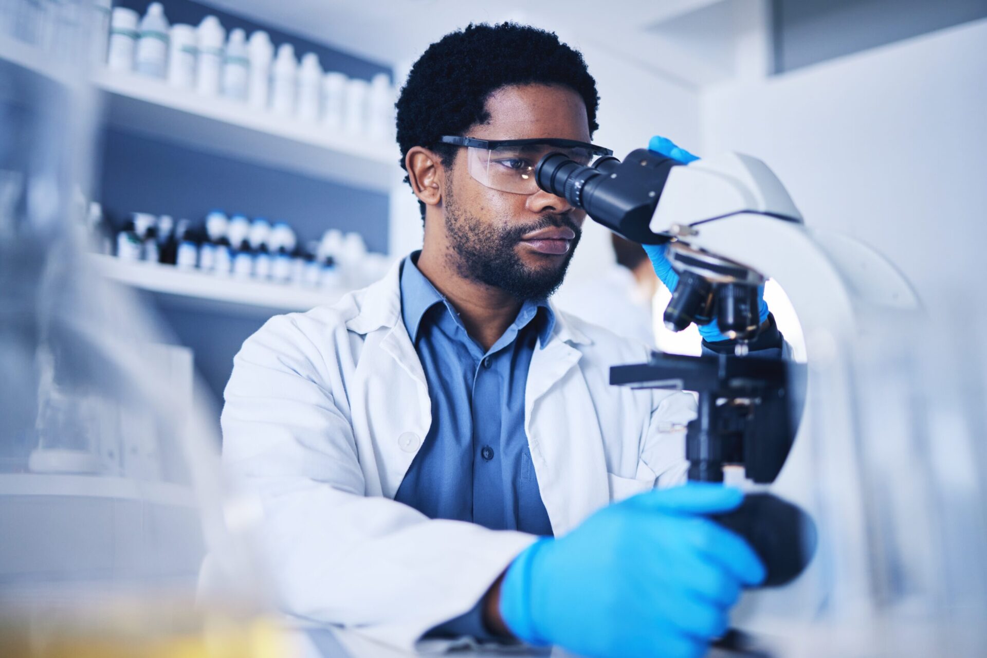 Microscope,,Science,And,Black,Man,Working,On,Study,In,Laboratory