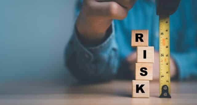 Businessman,Using,Tape,Measure,With,Risk,Wording,For,Risk,Analysis